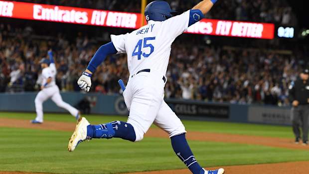 Jun 21, 2019; Los Angeles, CA, USA; Los Angeles Dodgers first baseman Matt Beaty (45) rounds the bases after hitting a walk off two run home run scoring second baseman Max Muncy (13) to defeat the Colorado Rockies 4-2 in the ninth inning at Dodger Stadium. Mandatory Credit: Jayne Kamin-Oncea-USA TODAY Sports